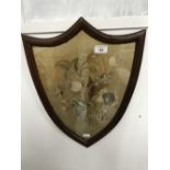 19th cent. Floral silk work embroidery in a shield shaped frame. 15½ins.