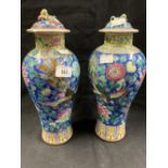 19th cent. Cantonese baluster shaped vases and covers, blue ground and multicoloured enamels