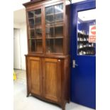 19th cent. Mahogany glazed two door bookcase/cupboard. 41ins. x 86ins.