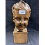 Treen: 20th cent. Carved oak child's head, signed Rene Sauwen. 14ins.