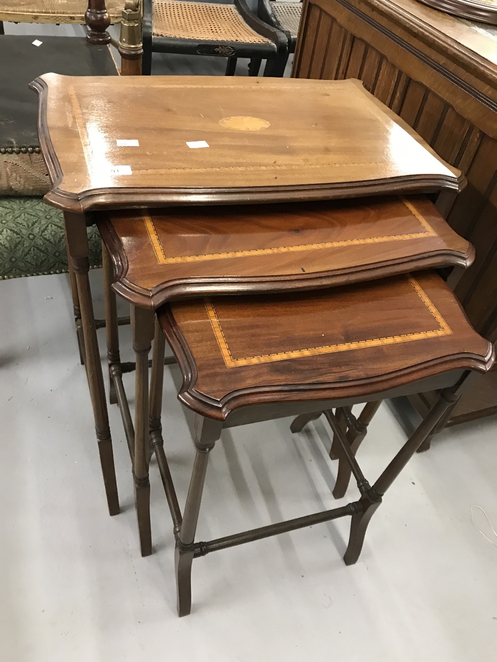 20th cent. Mahogany nest of three tables with oval inset inlaid decoration.