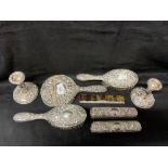 Hallmarked Silver: Dressing table set embossed decoration, mirror, brushes x 4, candlesticks and