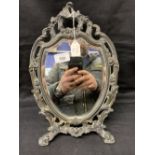 Early 20th cent. White metal shield shaped toilet mirror. Height 15ins.