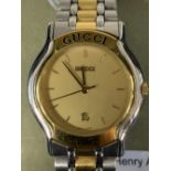 Watches: Ladies stainless steel and gold plated Gucci bracelet watch. Champagne coloured dial,