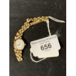 Watches: 9ct gold lady's Geneva wristwatch, white oval dial on a 9ct gold bracelet. Total weight 9.