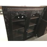 19th cent. Gothic style dark oak bookcase with two glazed doors and foliate design carving. 50ins. x