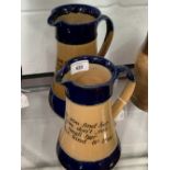 Royal Doulton: Waisted jugs, cobalt blue rim and base, with motto 'The Wisest of People' etc. 10ins.