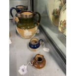 Doulton Lambeth: Miniature salt glaze jugs, blue glaze hunting example with hallmarked silver rim,
