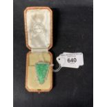 Jewellery: White metal art deco clip, triangular shape, centre set with carved jade with a border of