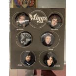 Rock/Pop: Rare set of six Wings Merchandising Badges on original presentation card.