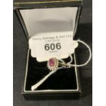 Hallmarked Jewellery: 9ct gold ring set with an oval ruby, estimated weight 0.60ct, surrounded by