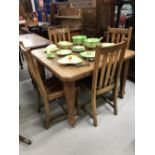 20th cent. Extending oak dining table and four oak dining chairs.