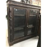 19th cent. Gothic style heavily carved dark oak bookcase with glazed doors. 50ins. x 48ins. x