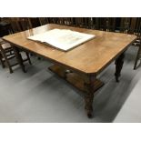 19th cent. Oak extending dining table on carved baluster supports with castors, two inserts.
