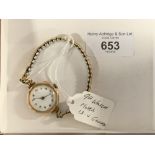 Watches: 9ct gold lady's watch, white round dial attached to a rolled gold expanding bracelet.