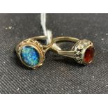 Jewellery: Two metal rings, one set with an oval garnet, the other with an oval opal triplet.