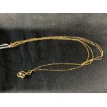 Jewellery: Two yellow metal necklets, one with a twisted knot pendant attached, the other plain.