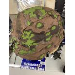 Militaria: WWII pattern German Steel Helmet with a zimmerit camouflage painted finish, together with
