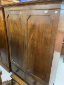 20th cent. Mahogany two door over two drawer wardrobe. 42½ins. x 18ins. x 69ins.