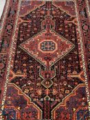 Carpets & Rugs: 20th cent. Persian/Hamadan carpet. Red ground, central medallion, decorated with