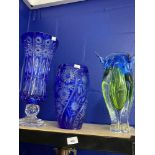 20th cent. Glassware: Blue overlay cut glass vase with flower spray panels. 11ins. Blue overlay
