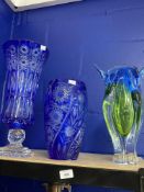 20th cent. Glassware: Blue overlay cut glass vase with flower spray panels. 11ins. Blue overlay