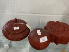 Chinese 20th cent. Carved red lacquer treen box of geometric form, another spherical painted, plus