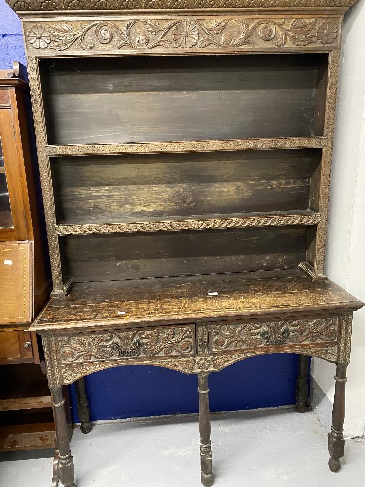 18th cent. Style oak dresser, with later carved floral decoration on five gun barrel supports.