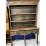 18th cent. Style oak dresser, with later carved floral decoration on five gun barrel supports.