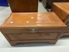 20th cent. Chinese hardwood chest the panels carved with bamboo relief on step bracket supports.