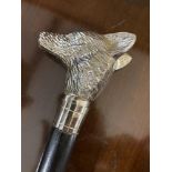 20th cent. Ebonised walking stick with white metal hounds head grip.
