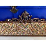19th cent. Mahogany bed head with ornate scrollwork frame and patterned fabric back.