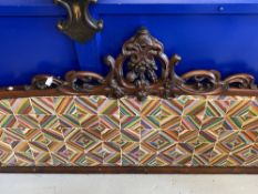 19th cent. Mahogany bed head with ornate scrollwork frame and patterned fabric back.