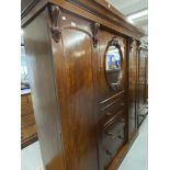 19th cent. Mahogany three section compactum with mirrored door over three drawer central section,