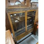20th cent. Oak display cabinet, two beaded & glazed doors over two drawers on ovoid supports with