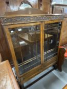 20th cent. Oak display cabinet, two beaded & glazed doors over two drawers on ovoid supports with