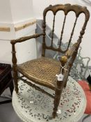 19th cent. Child's oak music chair with spindle back and lattice pattern seat.