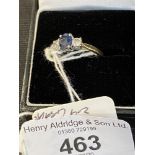 Hallmarked Jewellery: Ring three stone claw set in white with a single oval cut sapphire,