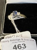 Hallmarked Jewellery: Ring three stone claw set in white with a single oval cut sapphire,