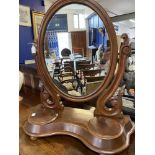 Victorian mahogany toilet mirror with oval plate, two compartments to the serpentine shaped base.