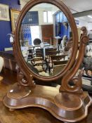 Victorian mahogany toilet mirror with oval plate, two compartments to the serpentine shaped base.