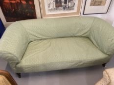 19th cent. Three seat settee green loose cover over liner on turned supports.