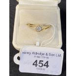 Hallmarked Jewellery: Diamond crossover ring set with a single brilliant cut stone estimated