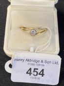 Hallmarked Jewellery: Diamond crossover ring set with a single brilliant cut stone estimated