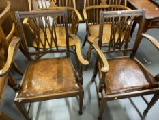 Georgian style mahogany elbow chairs with a reed rail back on square tapered legs and brown