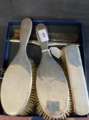 Silver: Four piece dressing table set, two hairbrushes, one comb, and one clothes brush,