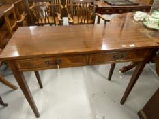 Reproduction mahogany side table fitted two drawers on square tapered legs. 42ins.