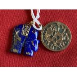 Jewellery: Yellow metal pendants, one in the form of a lapis lazuli elephant, the other circular