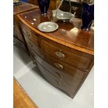 19th cent. Mahogany bow front chest of two over three drawers with ebony and boxwood inlay, on swept