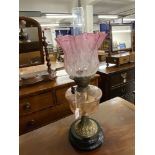 Lighting: 19th cent. Oil lamp gilt metal base, with pink tinted glass reservoir and graduated